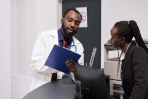 African American medical team working on patient checkup reports at Holistic Care Medicals