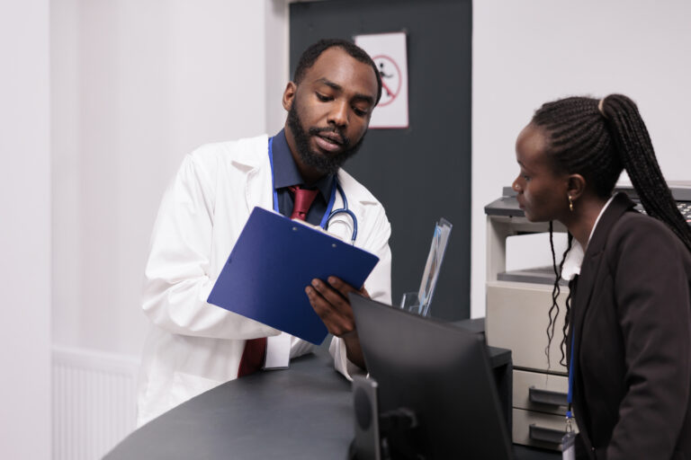 African American medical team working on patient checkup reports at Holistic Care Medicals