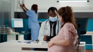 Doctor using digital tablet for patient consultation - Holistic Care Medicals